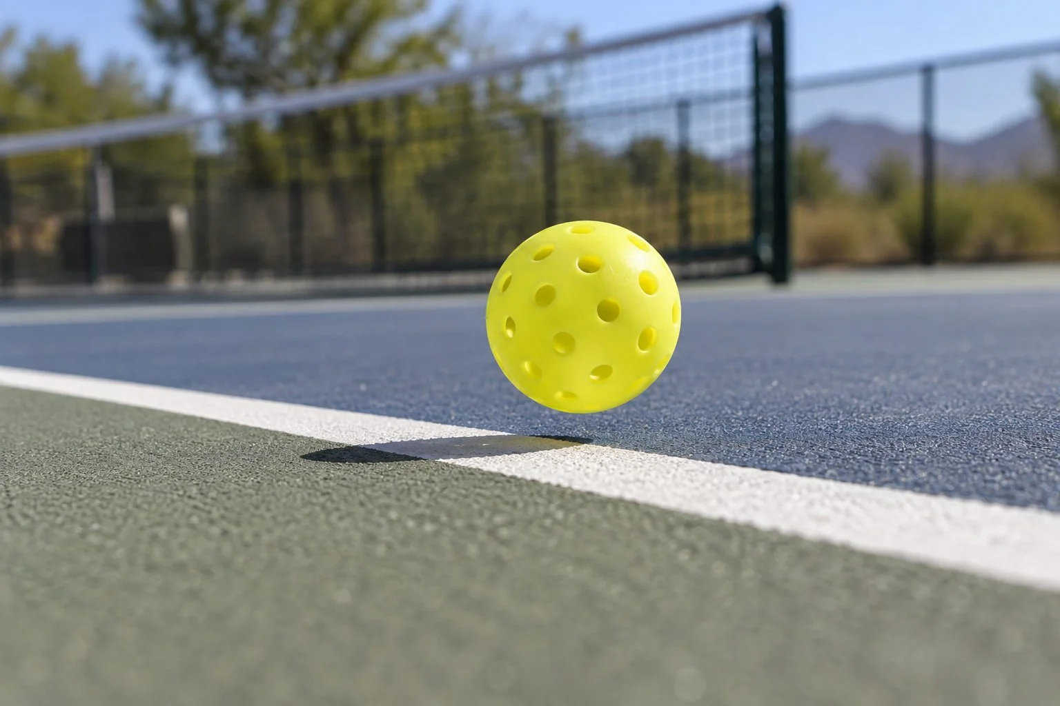 Players checking a close pickleball line call near the sideline