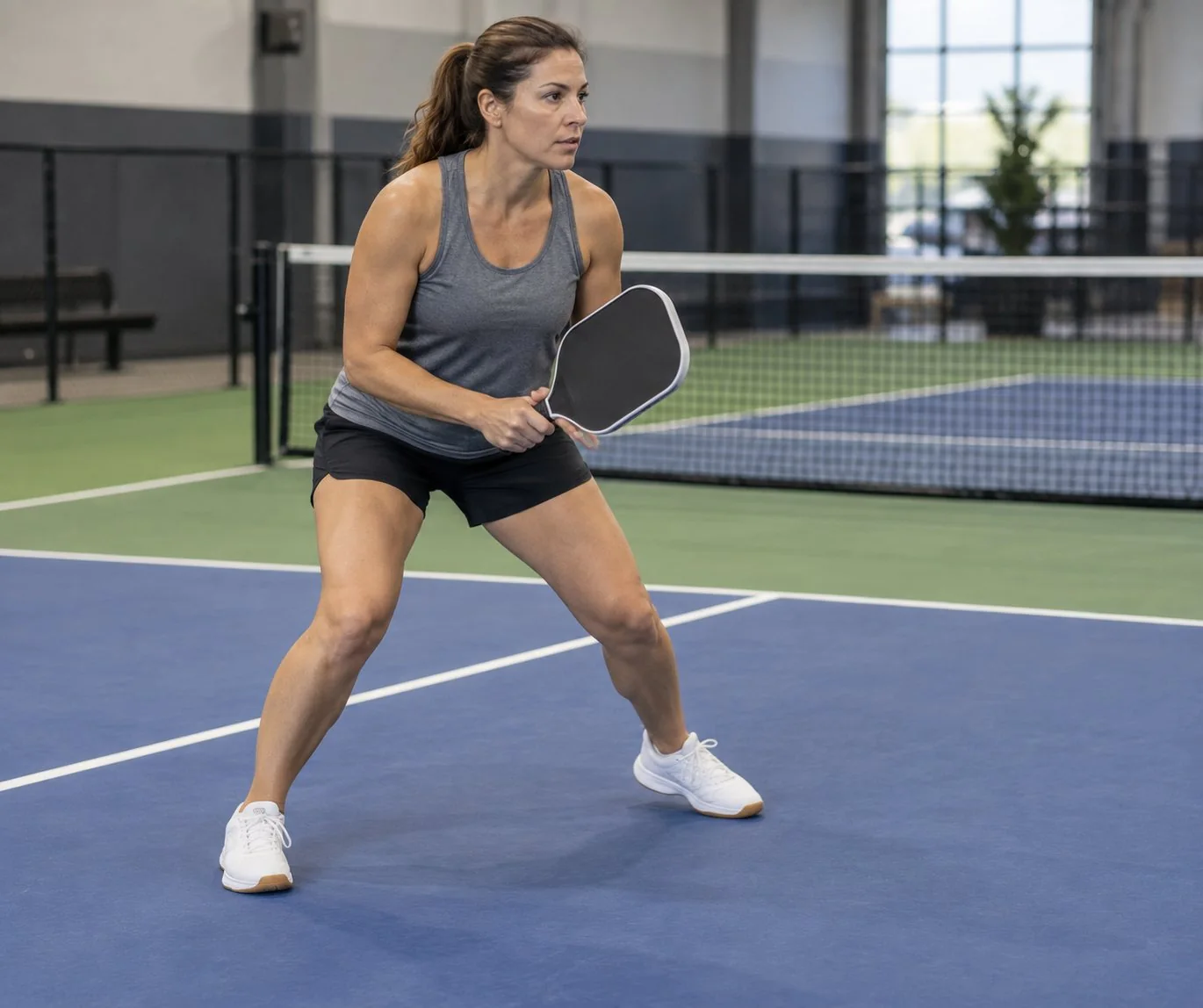 Player performing a gentle side-to-side shoe traction test indoors
