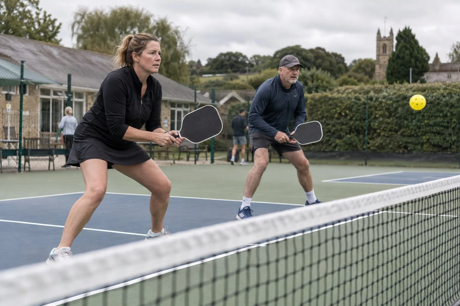 Partners practicing pickleball split steps before returns