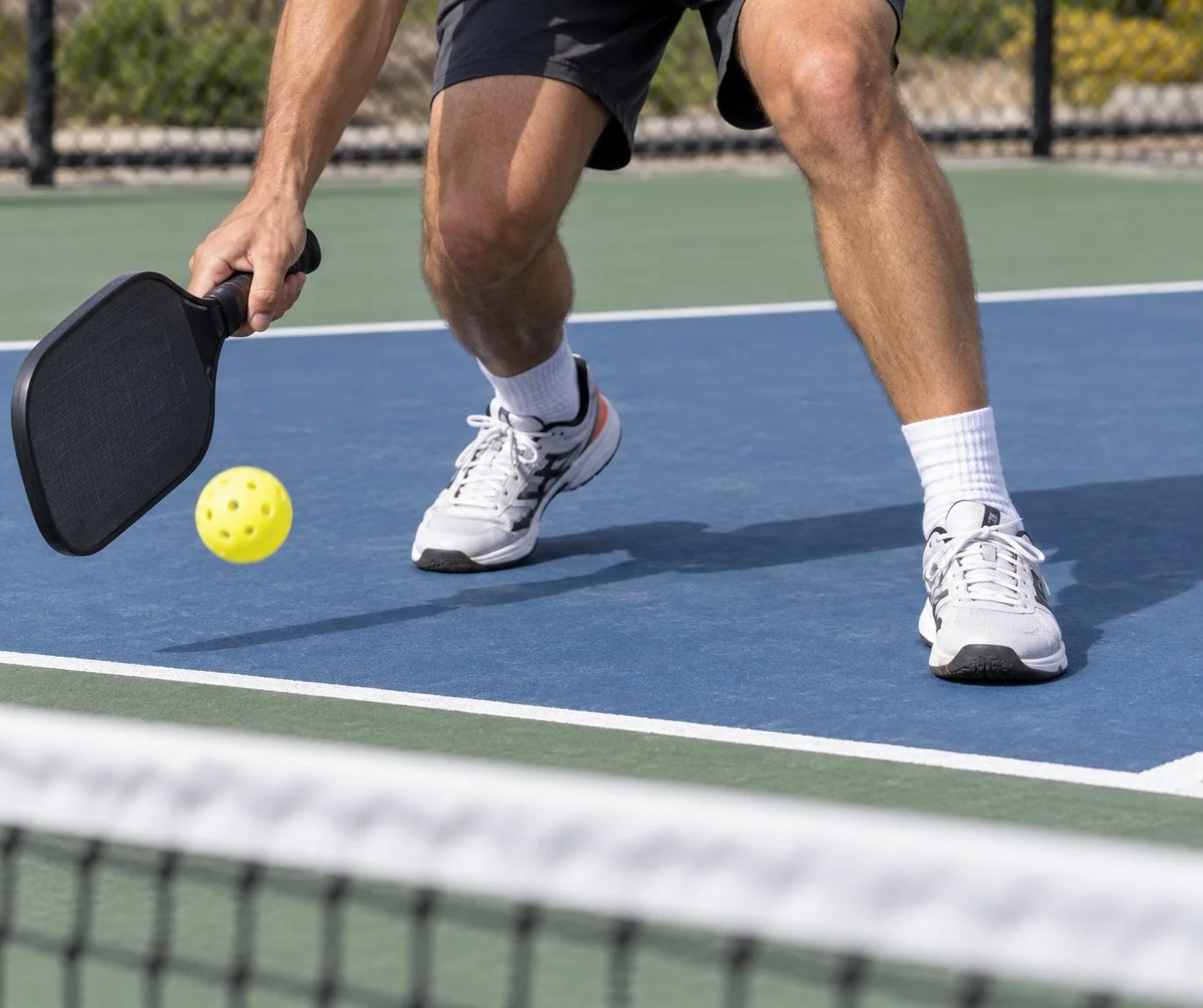Close-up of balanced pickleball kitchen footwork before contact